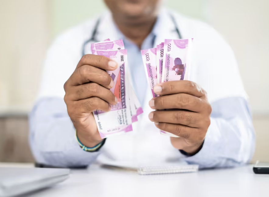 Doctor holding Indian rupee notes